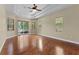 Bright main bedroom features hardwood floors, neutral walls, tray ceiling, and many windows at 614 Vintage Way, Brandon, FL 33511