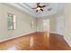 Bright main bedroom features hardwood floors, neutral walls, tray ceiling, and two doors at 614 Vintage Way, Brandon, FL 33511