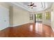 Bright main bedroom boasts hardwood floors, neutral walls, tray ceiling, door to the bathroom at 614 Vintage Way, Brandon, FL 33511
