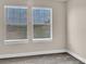Empty bedroom with neutral walls, plush carpet, and two windows with blinds at 11522 Cambium Crown Dr, Riverview, FL 33569