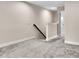 Carpeted hallway leading to a bedroom, featuring neutral walls and white trim at 11522 Cambium Crown Dr, Riverview, FL 33569