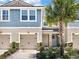 Inviting two-story home with blue siding, double garage, and lush landscaping at 11522 Cambium Crown Dr, Riverview, FL 33569