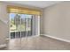 Bright living area with tiled floor and sliding glass doors leading to the backyard at 11522 Cambium Crown Dr, Riverview, FL 33569