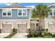 Charming two-story home with blue siding, double garage, and landscaped yard at 11522 Cambium Crown Dr, Riverview, FL 33569