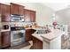 Kitchen with stainless steel appliances and light countertops at 9107 Moonlit Meadows Loop, Riverview, FL 33578