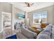Living room with gray sofas and a view into the bedroom at 9107 Moonlit Meadows Loop, Riverview, FL 33578