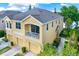 Two-story townhome with balcony, two-car garage, and lake view at 9107 Moonlit Meadows Loop, Riverview, FL 33578