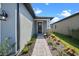 Charming home featuring a stone-accented entry with manicured landscaping and a welcoming front door at 3778 Maxwell Park Dr, Sun City Center, FL 33573