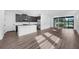 Modern kitchen with stainless steel appliances, white countertops, and sleek dark cabinetry at 3778 Maxwell Park Dr, Sun City Center, FL 33573