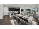 Bright open-concept living space with dark kitchen cabinets and a dining area overlooking the screened porch at 3778 Maxwell Park Dr, Sun City Center, FL 33573