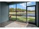 Screened in lanai with brick pavers offers serene views of the pond and golf course at 3778 Maxwell Park Dr, Sun City Center, FL 33573