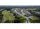 Aerial view of a community with houses, a golf course, and a lake at 3778 Maxwell Park Dr, Sun City Center, FL 33573