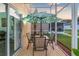 Screened patio with table and chairs, perfect for outdoor dining at 12711 Royal George Ave, Odessa, FL 33556