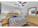 Well-lit bedroom featuring a comfortable bed and updated furniture at 12711 Royal George Ave, Odessa, FL 33556