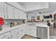 Modern kitchen with white cabinets and a breakfast bar at 12711 Royal George Ave, Odessa, FL 33556