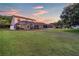 Large backyard with screened pool and patio area at sunset at 12711 Royal George Ave, Odessa, FL 33556