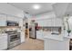 Modern kitchen with white cabinets, stainless steel appliances, and quartz countertops at 12711 Royal George Ave, Odessa, FL 33556