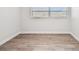 Simple bedroom with wood-look flooring and window at 5061 Jasmine Cir, St Petersburg, FL 33714