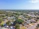 Aerial view showing a house among other houses and a large tree in a residential neighborhood at 5061 Jasmine Cir, St Petersburg, FL 33714