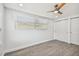 Bright bedroom with ceiling fan, window, and double closets at 5061 Jasmine Cir, St Petersburg, FL 33714