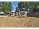 Newly renovated home with a landscaped front yard and wood fence at 5061 Jasmine Cir, St Petersburg, FL 33714