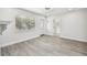 Spacious living area with wood-look floors and an entryway with a glass door at 5061 Jasmine Cir, St Petersburg, FL 33714