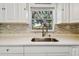Modern kitchen sink with quartz countertop and a view to the backyard at 5061 Jasmine Cir, St Petersburg, FL 33714