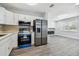 Modern kitchen with stainless steel appliances and white cabinets at 5061 Jasmine Cir, St Petersburg, FL 33714