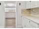 Bright kitchen features white shaker cabinets, quartz countertops, and mosaic backsplash at 5061 Jasmine Cir, St Petersburg, FL 33714
