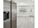 Stainless steel refrigerator in a kitchen with grey flooring at 5061 Jasmine Cir, St Petersburg, FL 33714