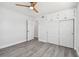 Bedroom with grey floors, ceiling fan, and double door closet at 5061 Jasmine Cir, St Petersburg, FL 33714