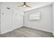 Bedroom with grey floors, ceiling fan, and double door closet at 5061 Jasmine Cir, St Petersburg, FL 33714