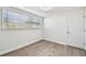 Spacious bedroom with wood-look floors and large window at 5061 Jasmine Cir, St Petersburg, FL 33714