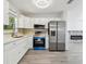Modern kitchen with stainless steel appliances and white cabinets at 5061 Jasmine Cir, St Petersburg, FL 33714
