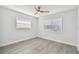 Bright bedroom with grey floors and a ceiling fan at 5061 Jasmine Cir, St Petersburg, FL 33714