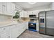 Modern kitchen with stainless steel appliances and white cabinets at 5061 Jasmine Cir, St Petersburg, FL 33714