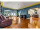 Spacious living room with hardwood floors, leather couch, and home office at 803 Bayshore Blvd, Tampa, FL 33606