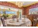 Elegant dining room with floral wallpaper, chandelier, and access to a sunroom at 803 Bayshore Blvd, Tampa, FL 33606