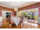 Elegant dining room with floral wallpaper, chandelier, and access to a sunroom with water views at 803 Bayshore Blvd, Tampa, FL 33606