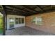 Covered back patio with brick flooring and a view of the yard at 1702 Blind Pond Ave, Lutz, FL 33549
