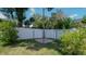 Spacious backyard with a white vinyl fence and a paved patio area at 1702 Blind Pond Ave, Lutz, FL 33549