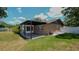 Brick home with covered patio and fenced yard at 1702 Blind Pond Ave, Lutz, FL 33549