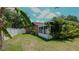 Home exterior showcasing sunroom and yard at 1702 Blind Pond Ave, Lutz, FL 33549