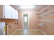 Laundry room with washer, dryer hookups, and shelving at 1702 Blind Pond Ave, Lutz, FL 33549
