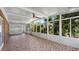 Bright sunroom with tile floor and ceiling fan at 1702 Blind Pond Ave, Lutz, FL 33549