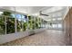 Spacious sunroom with tile floor and AC unit at 1702 Blind Pond Ave, Lutz, FL 33549