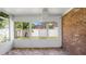 Sunroom with brick wall, tile floor, and view at 1702 Blind Pond Ave, Lutz, FL 33549