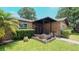 House entrance with covered porch and brick planters at 1702 Blind Pond Ave, Lutz, FL 33549