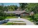 Aerial view of a single-story house with a circular driveway and landscaped yard at 1702 Blind Pond Ave, Lutz, FL 33549