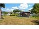 Brick house with a large backyard, covered patio, and sunroom at 1702 Blind Pond Ave, Lutz, FL 33549